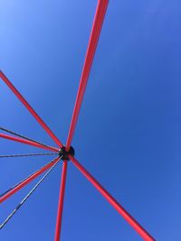 Low angle view of red built structure against clear blue sky