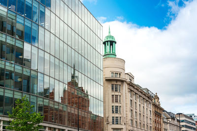 Low angle view of buildings in city against sky