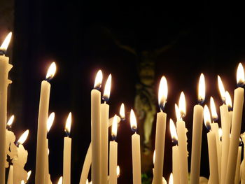 Close-up of burning candles in temple