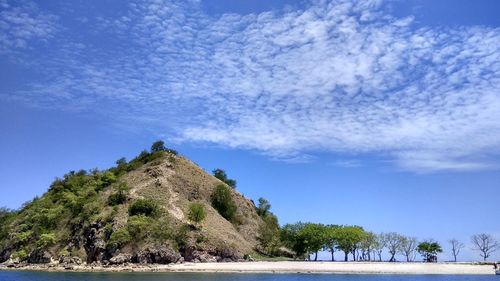 Scenic view of mountains against blue sky