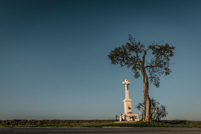 Traditional windmill on field against clear sky