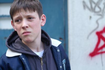 Worried young man looking away in city