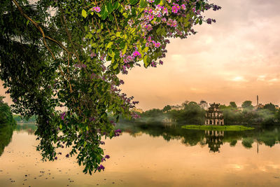 Scenic view of lake against sky at sunset