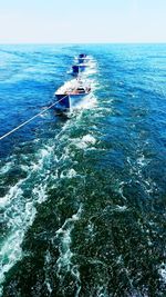 Boat sailing in sea against sky