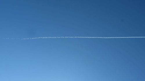 Vapor trail against clear blue sky