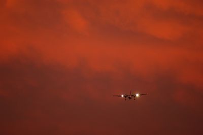 Silhouette of commuter airplane in evening sky