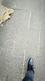 Low section of person standing on tiled floor