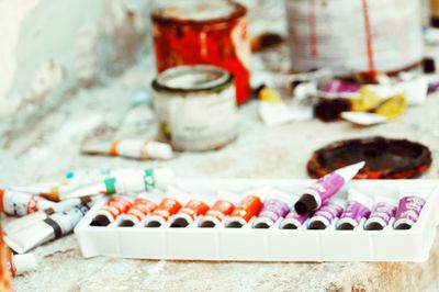 Close-up of various paint on table