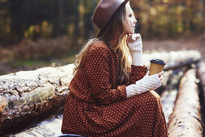 Midsection of woman holding smart phone outdoors
