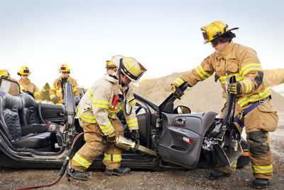 Firefighters cutting car during practice drill
