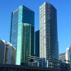 Low angle view of modern building against blue sky