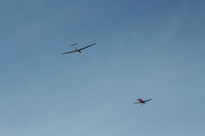 Low angle view of airplane flying in sky