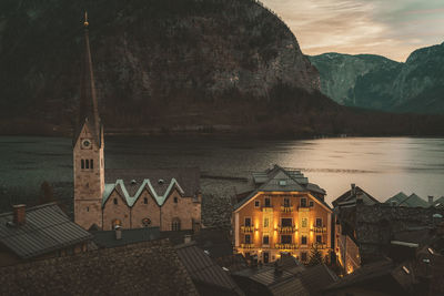 High angle view of townscape by sea against sky