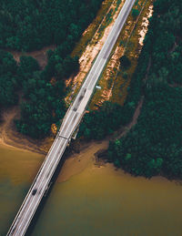 High angle view of bridge over road by trees