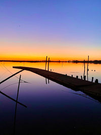 Scenic view of sea against orange sky