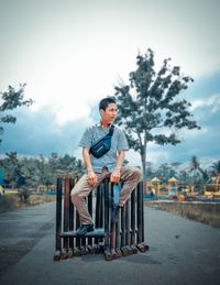 Man sitting on seat against sky