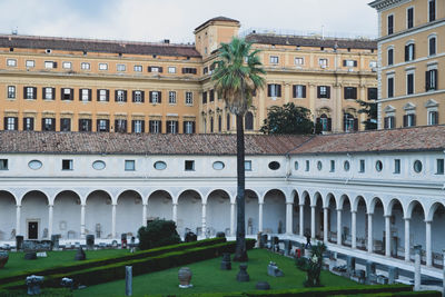 Digital composite image of buildings and lawn against sky
