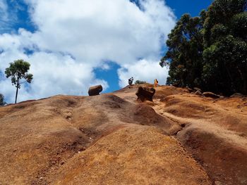 Rock formations on landscape against sky