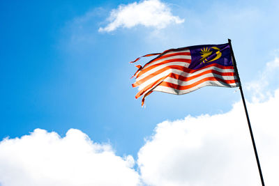 Low angle view of flag against sky