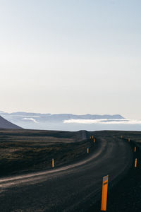 Road passing through landscape against sky