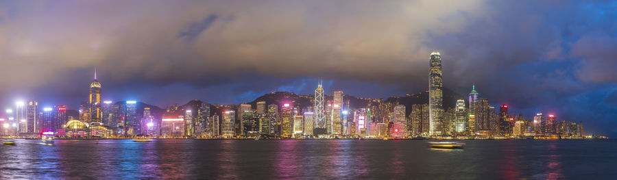 Panoramic view of illuminated buildings against sky at night