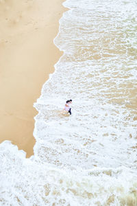 High angle view of man surfing on beach