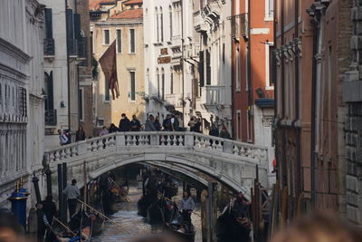 Crowd of people on bridge over canal