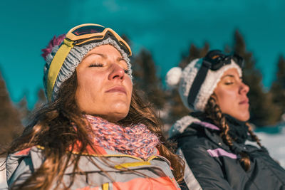 Close-up of women with closed eyes in sunny day