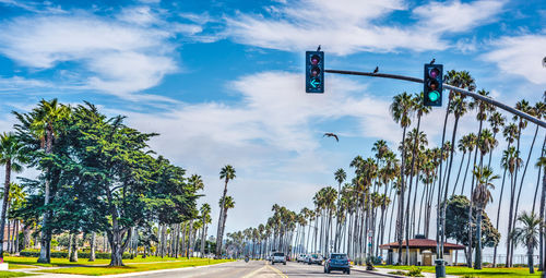 Low angle view of road signal against sky