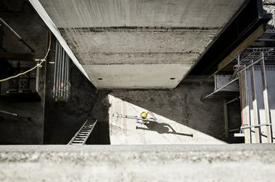 Construction worker carrying pillar