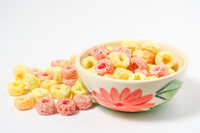 High angle view of candies in bowl against white background