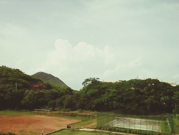 Scenic view of mountains against cloudy sky