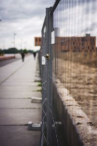 View of metal bridge in city against sky