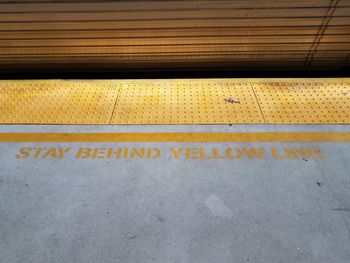 High angle view of text on railroad station platform