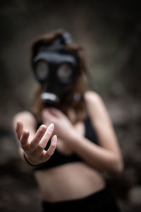 Midsection of woman holding mask