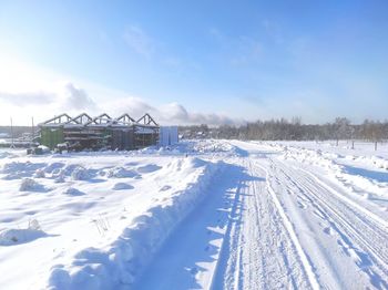 Snow covered land against sky