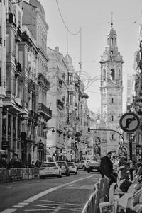 City street and buildings against sky