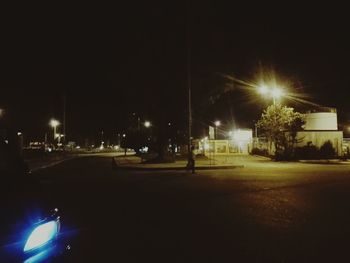 Illuminated road in city at night