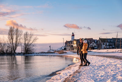 Man standing on snow against sky during winter