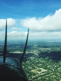 Cropped image of airplane flying over city