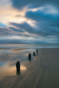 Three groynes pointing to a wintery seascape