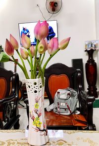 Close-up of tulips in vase on table at home