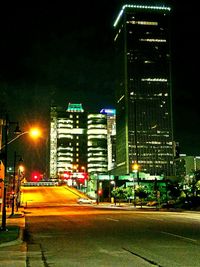 Illuminated city street at night