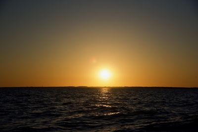 Scenic view of sea against clear sky during sunset