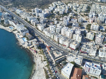 High angle view of swimming pool by buildings in city