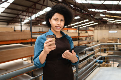 Portrait of young woman standing in subway