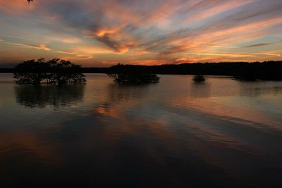 Scenic view of lake against romantic sky at sunset