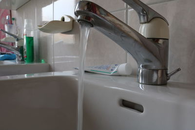 Close-up of faucet in bathroom