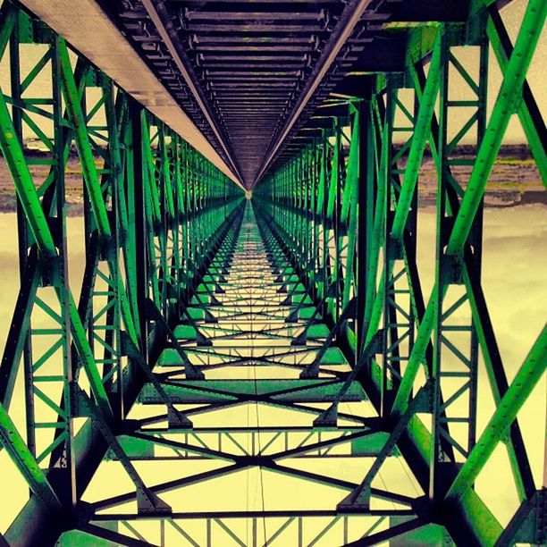 diminishing perspective, the way forward, built structure, architecture, metal, pattern, indoors, in a row, vanishing point, ceiling, railing, connection, metallic, repetition, low angle view, sunlight, no people, shadow, day, footbridge