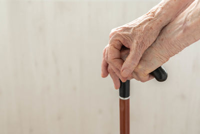 Midsection of man holding hands against wall